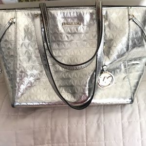 MK bag , used but good condition. Lots of pockets, silver metallic , size large